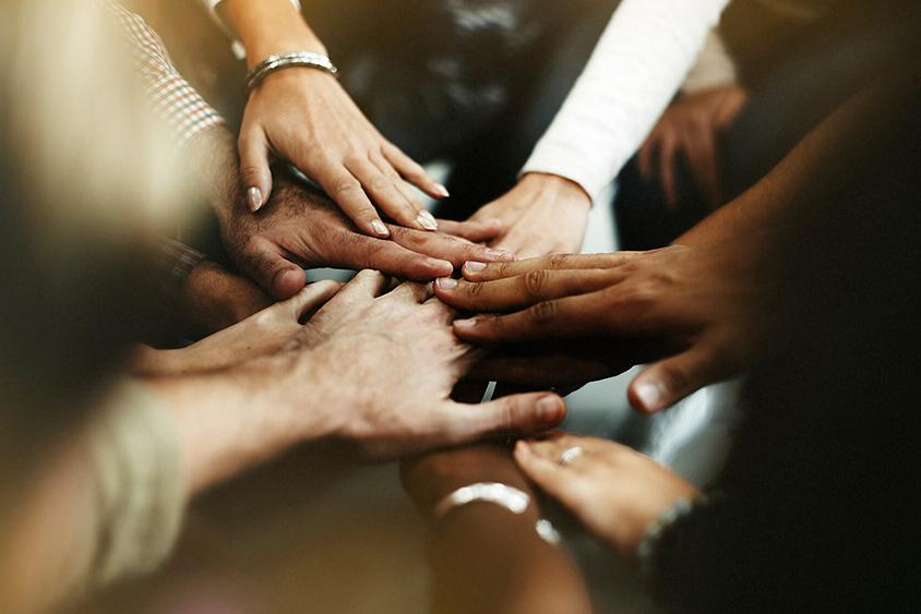 Diverse people joining their hands