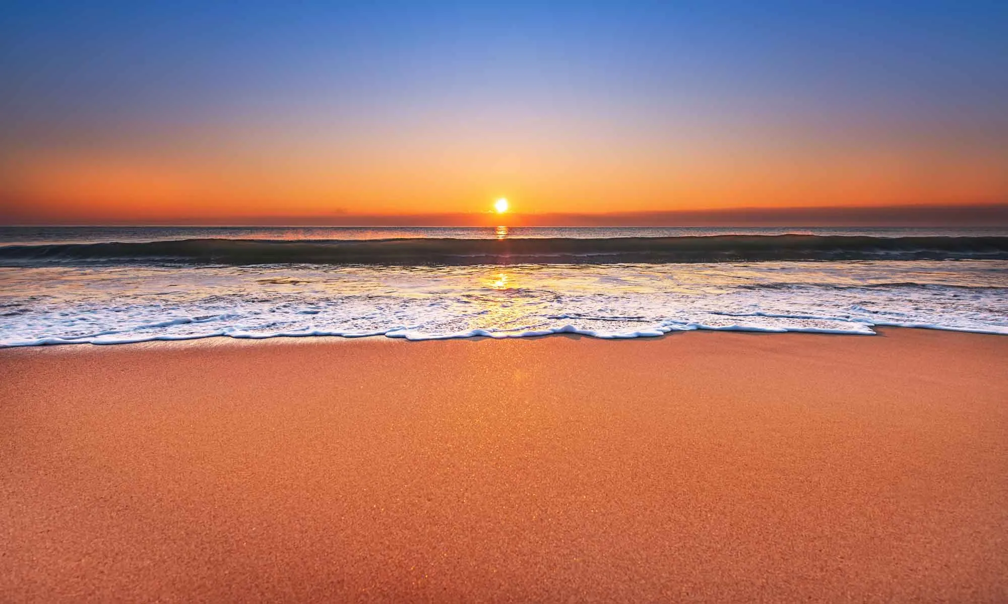 Majestic ocean sunset with a breaking wave